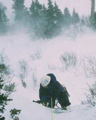 John following on a windy climb